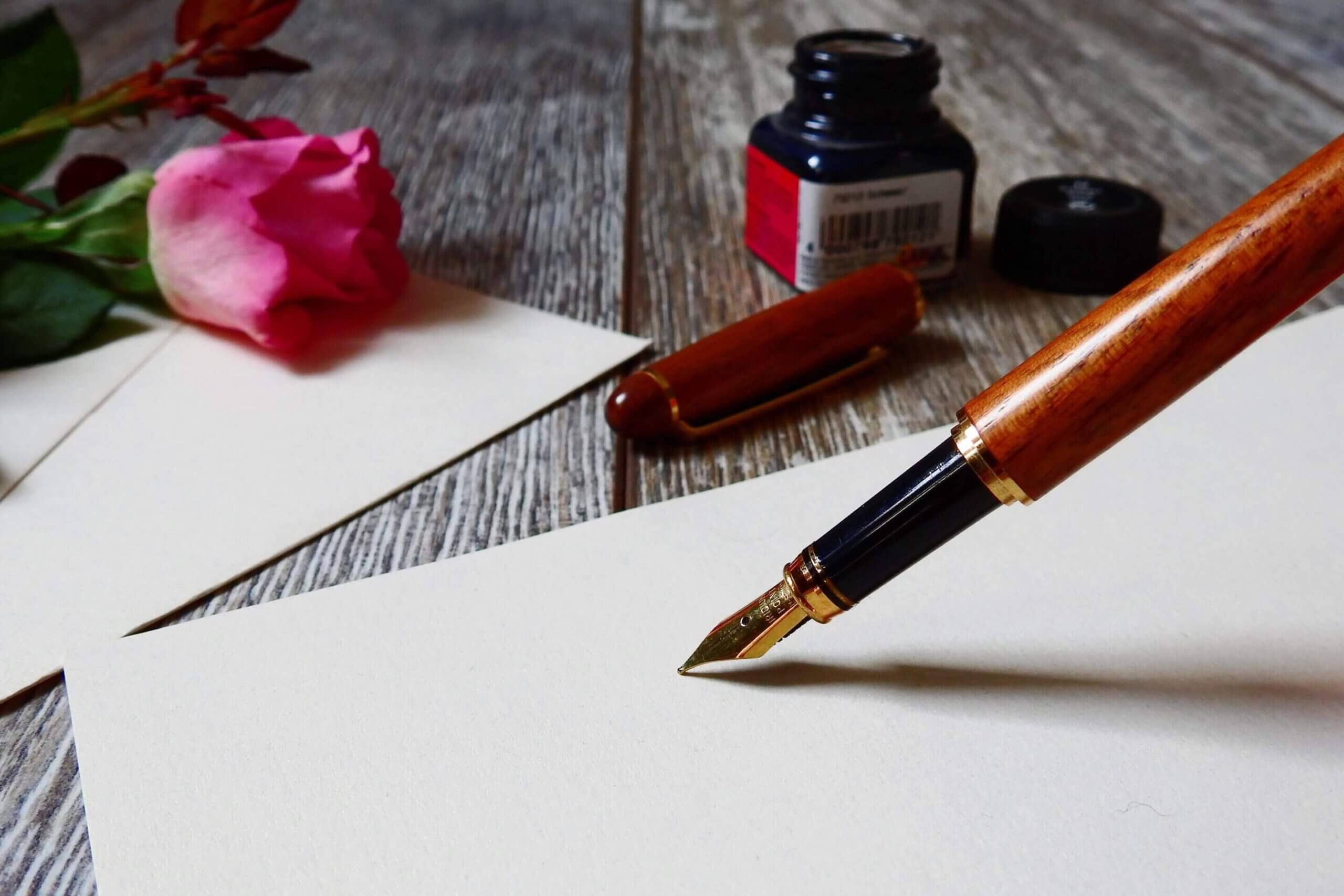 Inkwell pen writing on stationery