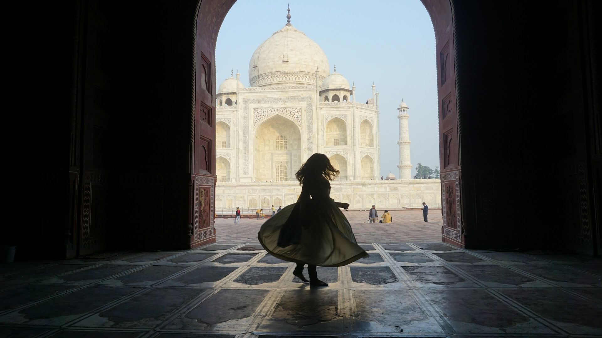 Woman in silhouette near the Taj Mahal