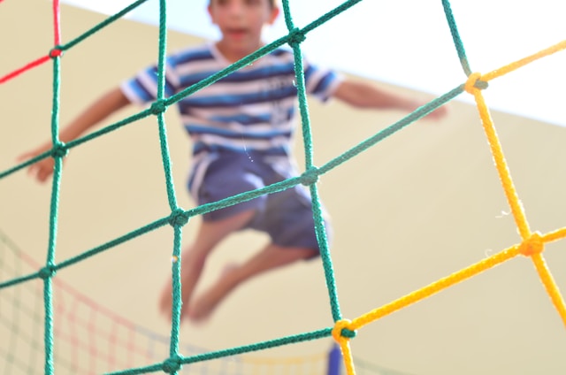 Young boy bouncing on a trampoline